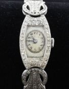 A lady`s 1930`s Art Deco platinum and diamond Rolex cocktail watch, of tonneau form, with oval