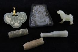 A group of six Chinese jade and serpentine carvings, comprising a celadon jade mouth piece, a