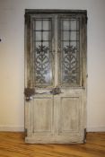 A 19th century oak framed French door, fitted a pair of pierced wrought iron panels, 6ft 7in. x 3ft
