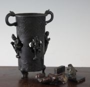 A Japanese bronze two handled cup, a copper covered netsuke and a bronze ram`s head, the bronze