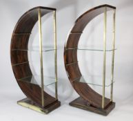 An Art Deco style calamander and brass circular bookcase, with plate glass shelves and platform