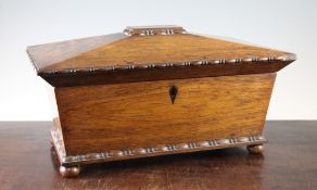 A 19th century rosewood oversized sarcophagus shaped tea caddy, with turned mouldings and squat