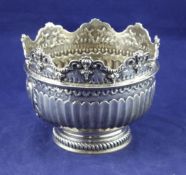 A late Victorian small rose bowl, modelled as a Monteith, with repousse mask and scroll decoration