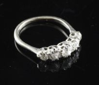 An 18ct white gold and graduated five stone diamond ring, size M.