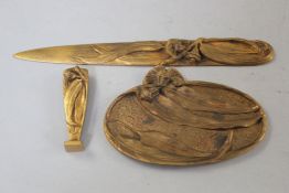 A French Art Nouveau gilt bronze three piece desk set, including a letter opener, seal and oval