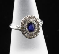 A 1920`s platinum, sapphire and diamond oval target dress ring, with pierced shoulders, size M.