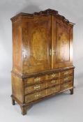 An 18th century Dutch walnut cabinet, fitted two cupboard doors over three long drawers, on