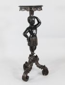 A late 19th century Italian carved Blackamoor torchere, on three scrolling leaf supports, H.3ft