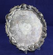 A George II silver salver, of shaped circular form, with shell, scroll border and later engraved