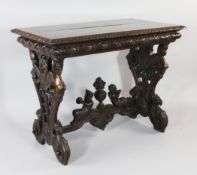 A 19th century Continental carved walnut oblong centre table, with pierced trestle ends, winged