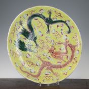 A Chinese famille rose `dragon` dish, Kangxi mark, Republic period, painted with an iron red and