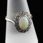 An 18ct gold, opal and diamond oval cluster ring, size Q.