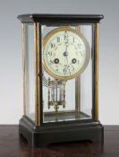 An early 20th century French four glass mantel clock, with floral painted dial and mercury pendulum,