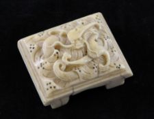 A Chinese ivory belt buckle, 19th century, of rectangular form, carved in relief with a dragon