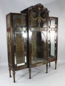 An early 20th century parcel gilt mahogany breakfront display cabinet, with mirror bordered glazed