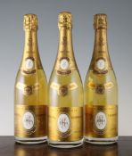Eight bottles of Louis Roederer Cristal Champagne 1990; levels all 0.5cm, six with German import