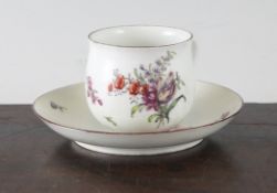 A Chelsea coffee cup and saucer, c.1756, decorated with flowers and insects, red anchor marks,