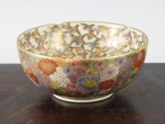 A Japanese Satsuma pottery thousand flower and bird bowl, Meiji period, the interior with numerous