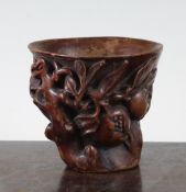 A Chinese bamboo libation cup, carved in high relief with pomegranate on branches issuing from a