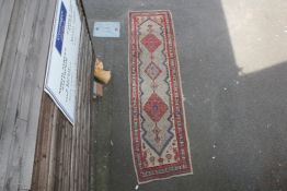 A Sarab runner, with three diamond motifs in a geometric field, on a beige ground, with three row