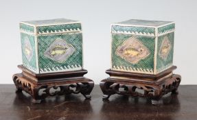 A pair of Chinese famille verte glazed biscuit porcelain square boxes and covers, probably Kangxi