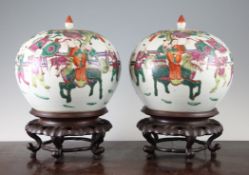 A pair of Chinese famille rose globular jars and covers, each painted with figures riding qilin