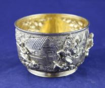 An Edwardian silver circular sugar bowl, decorated with continuous village scene after Teniers,
