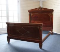 A French Empire style double bed, gilt brass mounted with female mask corbels and Anthemion and