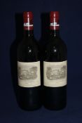 Two bottles of Chateau Lafite 1990, Premier Cru Classe, Pauillac; both into neck, slightly grazed