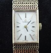 A lady`s 1960`s 9ct gold Omega manual wrist watch, with rectangualr dial and baton numerals,