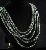 An Indian? multi strand unpolished facet cut emerald necklace, 20in.