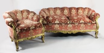 A Victorian carved giltwood three piece suite, the scallop shaped backs upholstered in a pink and