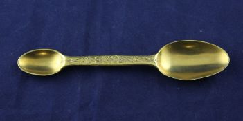 A Victorian silver gilt double ended medicine? spoon, with chased foliate stem, Thomas Johnson I,