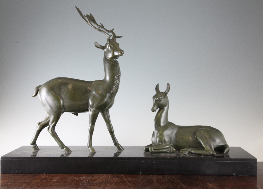 A 19th century French green patinated metal figure group, modelled as a stag and doe, on rectangular