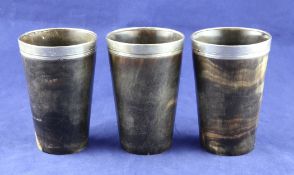 A set of three Victorian silver mounted horn beakers, of tapering form, with glazed bases, Thomas