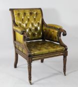 A mahogany library chair, with green buttoned leather upholstery and part padded arms, on tapering