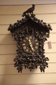 A Black Forest ebonised wood cuckoo clock, 2ft