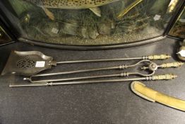 A set of three Georgian steel and brass fire irons, including tongs, a poker and a pierced shovel