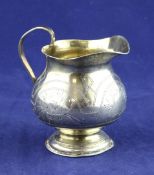 A late 19th century Russian 84 zolotnik silver cream jug, with engraved foliate and geometric