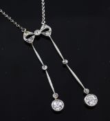 An Edwardian gold, silver and diamond set drop pendant necklace with bow shaped suspension, on a