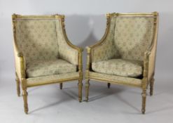 A Louis XVI design carved giltwood wingback armchair, with floral decoration and fluted arms and