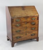A George III mahogany bureau, the fall front with fitted interior over four long graduated