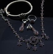 Five items of Victorian garnet set jewellery, comprising a necklace, stiff bracelet, pair of