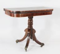 A Regency mahogany folding card table, on turned central column, downswept supports and brass