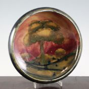 A Moorcroft `Eventide Landscape` bowl, c.1918-29, on dark mottled ground, inscribed `W Moorcroft`