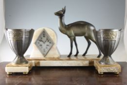 An Art Deco brown onyx mantel clock, mounted with a patinated brass model of a deer with silvered