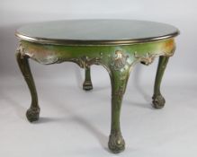A Continental green painted parcel gilt circular extending dining table, with shell carved knees and