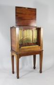 An unusual 19th century mahogany bell piano, modelled as an upright pipe organ, with twenty one