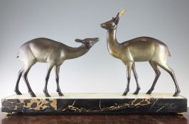 An Art Deco patinated metal bronze figure group of two gazelles, on green onyx and black veined
