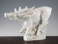 A large Royal Copenhagen white glazed figure of a crouching stag amid foliage, printed marks and